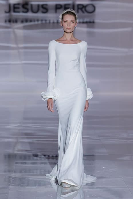 5 White elegance Jesus Peiro Long-established Spanish bridal house Jesus Peiro delivers a masterclass in understated style with this crepe dress. Featuring a wide bateau neckline, low back and long sleeves, it has a beautifully simple and fluid cut and – the only decorative element– fabulous flower petal details at the wrists. jesuspeiro.com